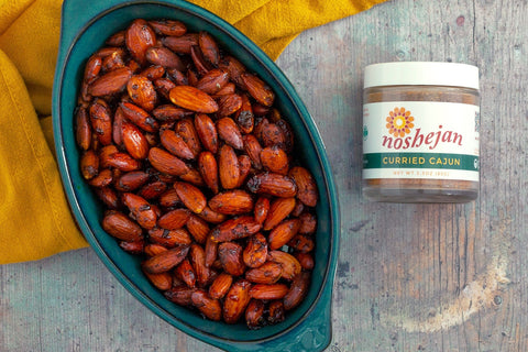 Noshejan Curried Cajun Roasted Almonds recipe completed on a wood background